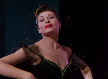 Movie still from “Hans Christian Andersen” (1952), directed by Charles Vidor – A woman in a black and green dress with flowers in her hair; Close Up shot, Low angle