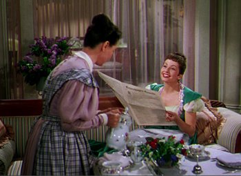 Movie still from “Hans Christian Andersen” (1952), directed by Charles Vidor – Two women are sitting at a dinner table; Medium shot, Over the shoulder angle