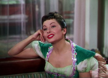 Movie still from “Hans Christian Andersen” (1952), directed by Charles Vidor – A woman sitting in front of a window with her hand on her face; Medium shot, High angle