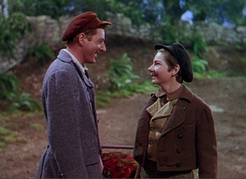 Movie still from “Hans Christian Andersen” (1952), directed by Charles Vidor – A man and a woman wearing hats talking to each other; Medium shot, Low angle