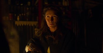 Movie still from “True History of the Kelly Gang” (2019), directed by Justin Kurzel – A woman is standing in a dark room; Close Up shot, Over the shoulder angle