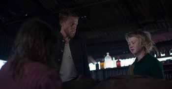 Movie still from “True History of the Kelly Gang” (2019), directed by Justin Kurzel – A man standing next to a woman in a room; Medium shot, Over the shoulder angle