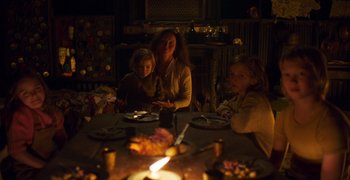Movie still from “True History of the Kelly Gang” (2019), directed by Justin Kurzel – A woman and two children sitting at a dinner table; Medium shot, High angle