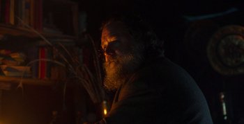 Movie still from “True History of the Kelly Gang” (2019), directed by Justin Kurzel – A man with a beard is holding a lit candle; Close Up shot, Low angle