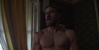 Movie still from “True History of the Kelly Gang” (2019), directed by Justin Kurzel – A shirtless man with blood all over his body; Medium shot, Over the shoulder angle