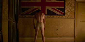 Movie still from “True History of the Kelly Gang” (2019), directed by Justin Kurzel – A man standing in front of a british union jack flag; Medium shot, Low angle