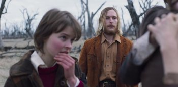 Movie still from “True History of the Kelly Gang” (2019), directed by Justin Kurzel – A man and a woman standing next to each other; Medium shot, Over the shoulder angle