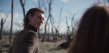 Movie still from “True History of the Kelly Gang” (2019), directed by Justin Kurzel – A man in a brown shirt is looking at the camera; Close Up shot, Over the shoulder angle