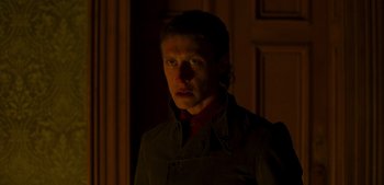 Movie still from “True History of the Kelly Gang” (2019), directed by Justin Kurzel – A man in a dark room with a light shining on his face; Close Up shot, Low angle