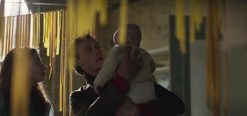 Movie still from “True History of the Kelly Gang” (2019), directed by Justin Kurzel – A woman holding a baby in her arms; Medium shot, Low angle