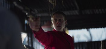 Movie still from “True History of the Kelly Gang” (2019), directed by Justin Kurzel – A man in a red jacket is holding a branch; Close Up shot, Low angle