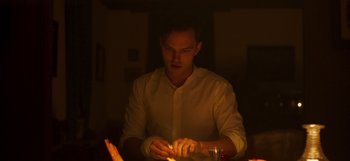 Movie still from “True History of the Kelly Gang” (2019), directed by Justin Kurzel – A man lighting a candle in a dark room; Medium shot, Low angle