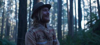 Movie still from “True History of the Kelly Gang” (2019), directed by Justin Kurzel – A man with long blonde hair wearing a hat; Medium shot, Low angle
