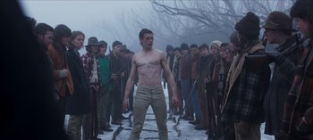 Movie still from “True History of the Kelly Gang” (2019), directed by Justin Kurzel – A group of young men standing next to each other on snow covered ground; Medium shot, Low angle