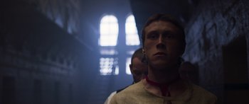 Movie still from “True History of the Kelly Gang” (2019), directed by Justin Kurzel – A man with a red tie standing next to another man in front of a window; Close Up shot, Low angle