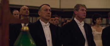 Movie still from “True History of the Kelly Gang” (2019), directed by Justin Kurzel – A man in a tuxedo standing next to another man in a suit; Close Up shot, Low angle
