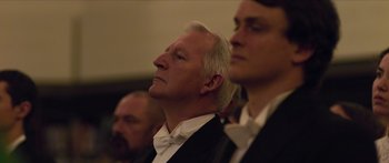 Movie still from “True History of the Kelly Gang” (2019), directed by Justin Kurzel – A man in a suit and tie looking upward; Close Up shot, Low angle