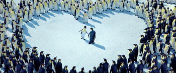 Movie still from “Happy Feet” (2006), directed by Warren Coleman – A large group of penguins standing on top of a snow covered ground; Extreme Wide shot, High angle