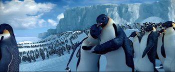 Movie still from “Happy Feet” (2006), directed by Warren Coleman – A couple of penguins standing on top of a snow covered slope; Medium shot, Low angle