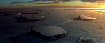 Movie still from “Happy Feet” (2006), directed by Warren Coleman – An aerial view of the ocean at sunset; Extreme Wide shot, High angle