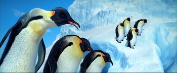 Movie still from “Happy Feet” (2006), directed by Warren Coleman – A group of penguins standing next to each other on the snow; Extreme Wide shot, Low angle