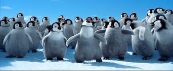 Movie still from “Happy Feet” (2006), directed by Warren Coleman – A group of penguins standing in the middle of the snow; Extreme Wide shot, Low angle