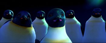 Movie still from “Happy Feet” (2006), directed by Warren Coleman – A group of penguins standing next to each other on top of a field; Close Up shot, Low angle