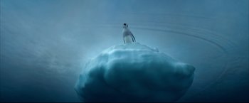 Movie still from “Happy Feet” (2006), directed by Warren Coleman – A bird sitting on top of an ice floe in the ocean; Extreme Wide shot, Low angle