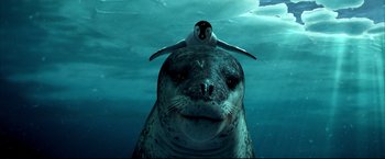 Movie still from “Happy Feet” (2006), directed by Warren Coleman – A seal with a penguin sitting on its head; Close Up shot, High angle