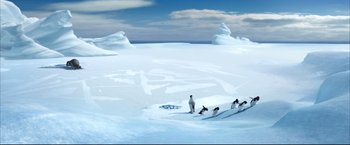 Movie still from “Happy Feet” (2006), directed by Warren Coleman – A group of penguins standing on top of a snow covered slope; Extreme Wide shot, High angle