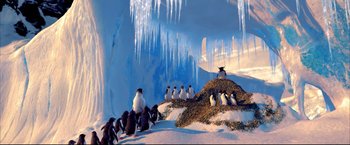 Movie still from “Happy Feet” (2006), directed by Warren Coleman – A group of penguins sitting on top of a pile of rocks; Extreme Wide shot, Low angle