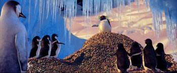Movie still from “Happy Feet” (2006), directed by Warren Coleman – A group of penguins standing on top of a pile of rocks; Medium shot, Low angle
