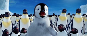 Movie still from “Happy Feet” (2006), directed by Warren Coleman – A baby penguin standing in front of a flock of penguins; Medium shot, Low angle