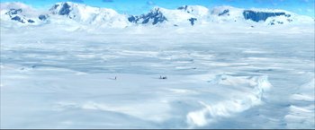 Movie still from “Happy Feet” (2006), directed by Warren Coleman – Two people are standing in the middle of a snow covered field; Extreme Wide shot, High angle