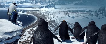 Movie still from “Happy Feet” (2006), directed by Warren Coleman – A couple of penguins sitting on top of a snow covered ground; Extreme Wide shot, High angle