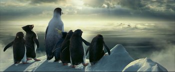 Movie still from “Happy Feet” (2006), directed by Warren Coleman – A group of penguins standing on top of a snow covered slope; Extreme Wide shot, Low angle