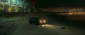 Movie still from “Happy Feet” (2006), directed by Warren Coleman – A car driving on the beach at night; Extreme Wide shot, High angle