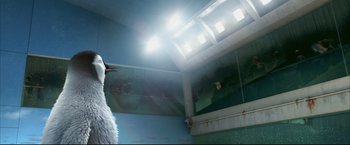 Movie still from “Happy Feet” (2006), directed by Warren Coleman – A penguin standing in front of a mirror in a room; Close Up shot, Low angle