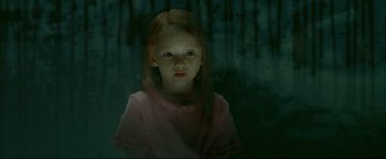 Movie still from “Happy Feet” (2006), directed by Warren Coleman – A young girl with red hair and a pink shirt is in a dark forest; Medium shot, High angle