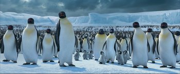 Movie still from “Happy Feet” (2006), directed by Warren Coleman – A large group of penguins standing on top of a snow covered ground; Extreme Wide shot, Low angle