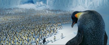 Movie still from “Happy Feet” (2006), directed by Warren Coleman – A large group of penguins in the snow; Extreme Wide shot, High angle