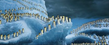 Movie still from “Happy Feet” (2006), directed by Warren Coleman – Many penguins that are standing on the ice; Extreme Wide shot, High angle