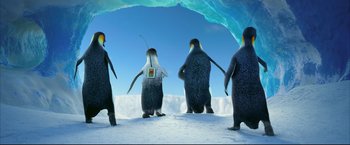 Movie still from “Happy Feet” (2006), directed by Warren Coleman – A group of penguins standing on top of a snow covered slope; Extreme Wide shot, Low angle