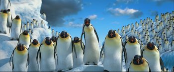 Movie still from “Happy Feet” (2006), directed by Warren Coleman – A group of penguins standing on top of a snow covered slope; Extreme Wide shot, Low angle