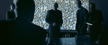 Movie still from “Happy Feet” (2006), directed by Warren Coleman – A man standing in front of a wall of penguins; Wide shot, Over the shoulder angle