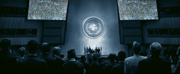 Movie still from “Happy Feet” (2006), directed by Warren Coleman – A group of people standing in front of a projection screen; Extreme Wide shot, High angle