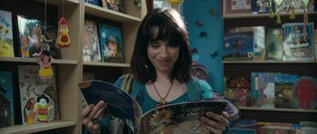 Movie still from “Happy-Go-Lucky” (2008), directed by Mike Leigh – A woman is reading a book in a room; Close Up shot, High angle