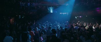 Movie still from “Happy-Go-Lucky” (2008), directed by Mike Leigh – A large group of people in a dark room; Extreme Wide shot, High angle