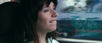 Movie still from “Happy-Go-Lucky” (2008), directed by Mike Leigh – A person in a car; Close Up shot, Over the shoulder angle