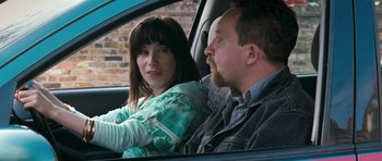 Movie still from “Happy-Go-Lucky” (2008), directed by Mike Leigh – A man and a woman sitting in the drivers seat of a car; Close Up shot, Over the shoulder angle